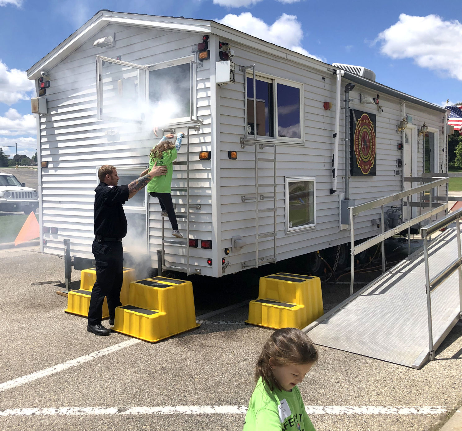 Children from a recent Safety Town program use a smoke house to practice fire safety